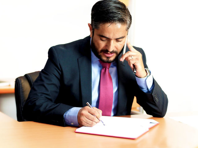 Man talking on phone at desk