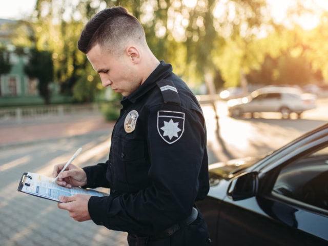 male cop doing paperwork